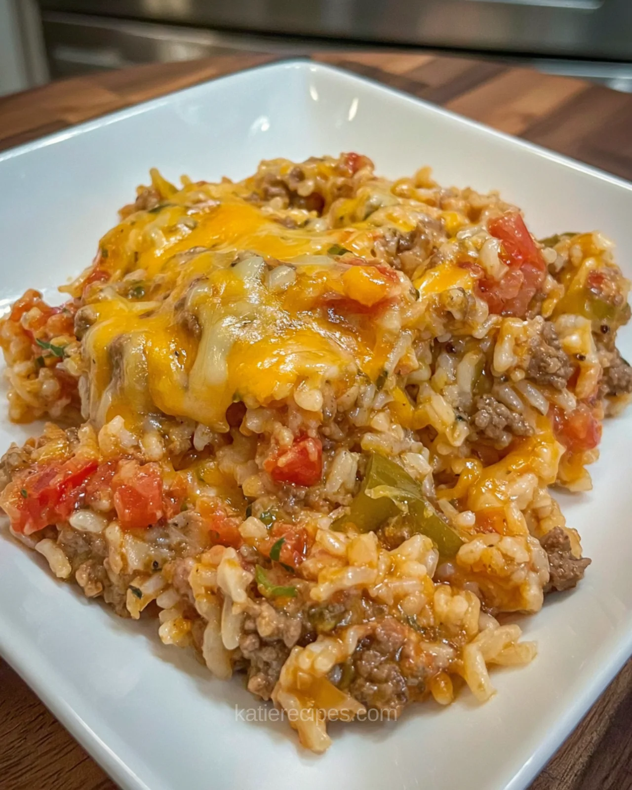 Cheesy taco beef and rice cooked in a skillet with melted cheese and seasoned ground beef