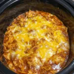 Slow cooker chicken enchilada casserole with melted cheese
