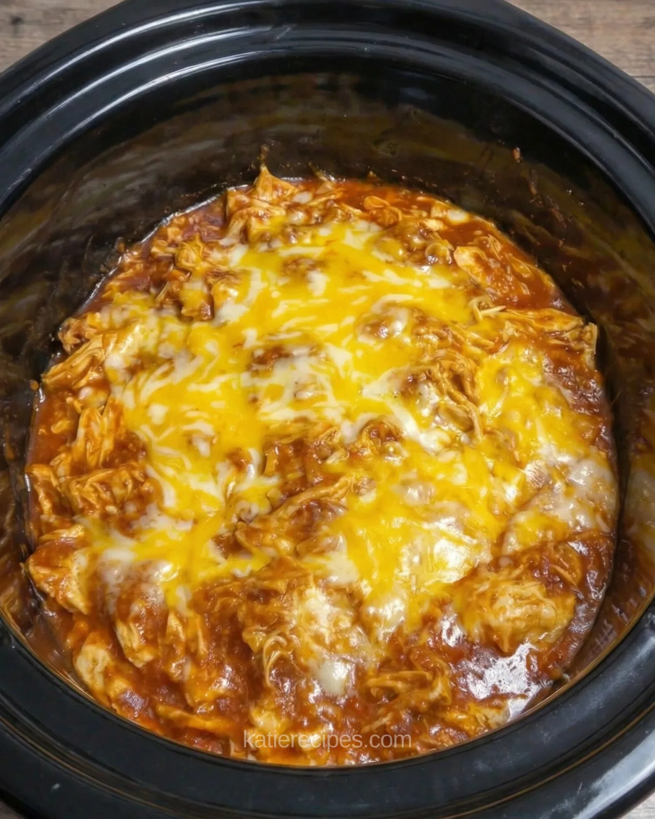 Slow cooker chicken enchilada casserole with melted cheese