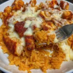 Cheesy queso chicken served over seasoned rice