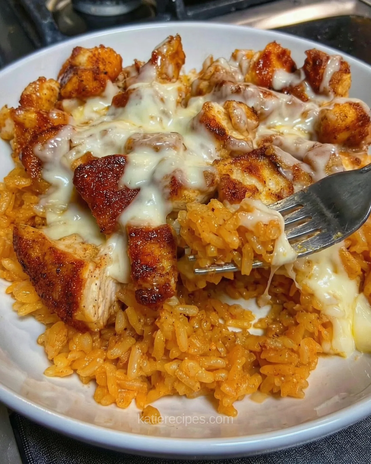 Cheesy queso chicken served over seasoned rice