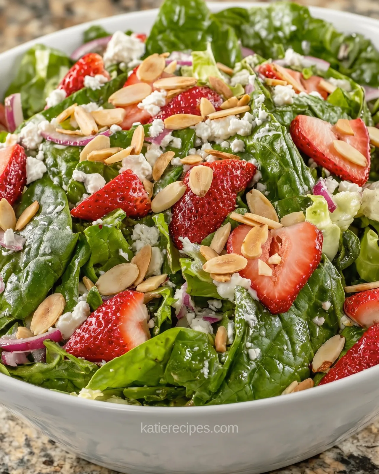 Easy summer salad with fresh strawberries, feta cheese and toasted almonds