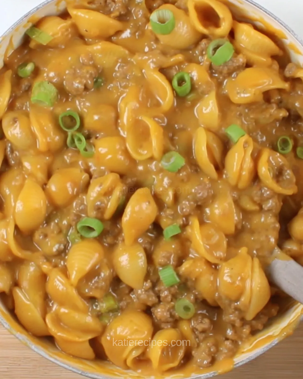 Creamy homemade hamburger helper cheeseburger pasta with shells and beef, topped with sliced green onion