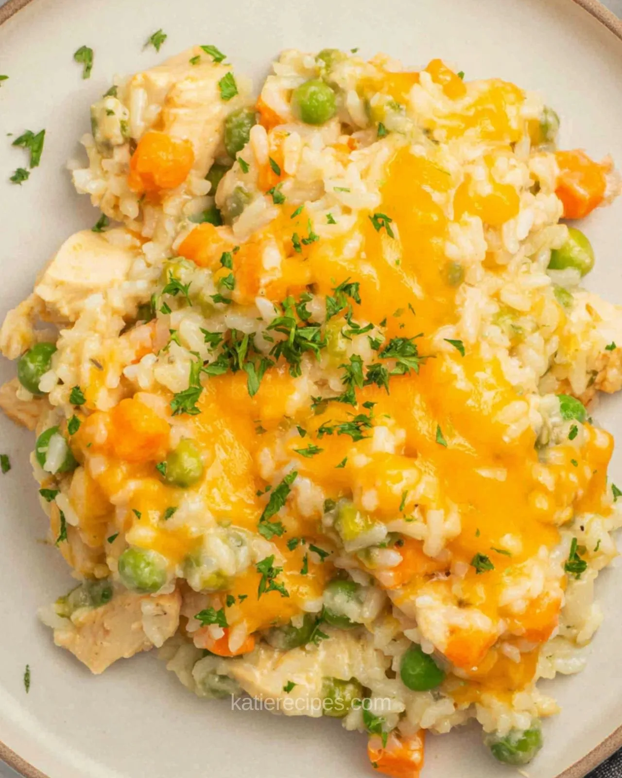 Scoop of creamy cheesy chicken and rice casserole on a plate