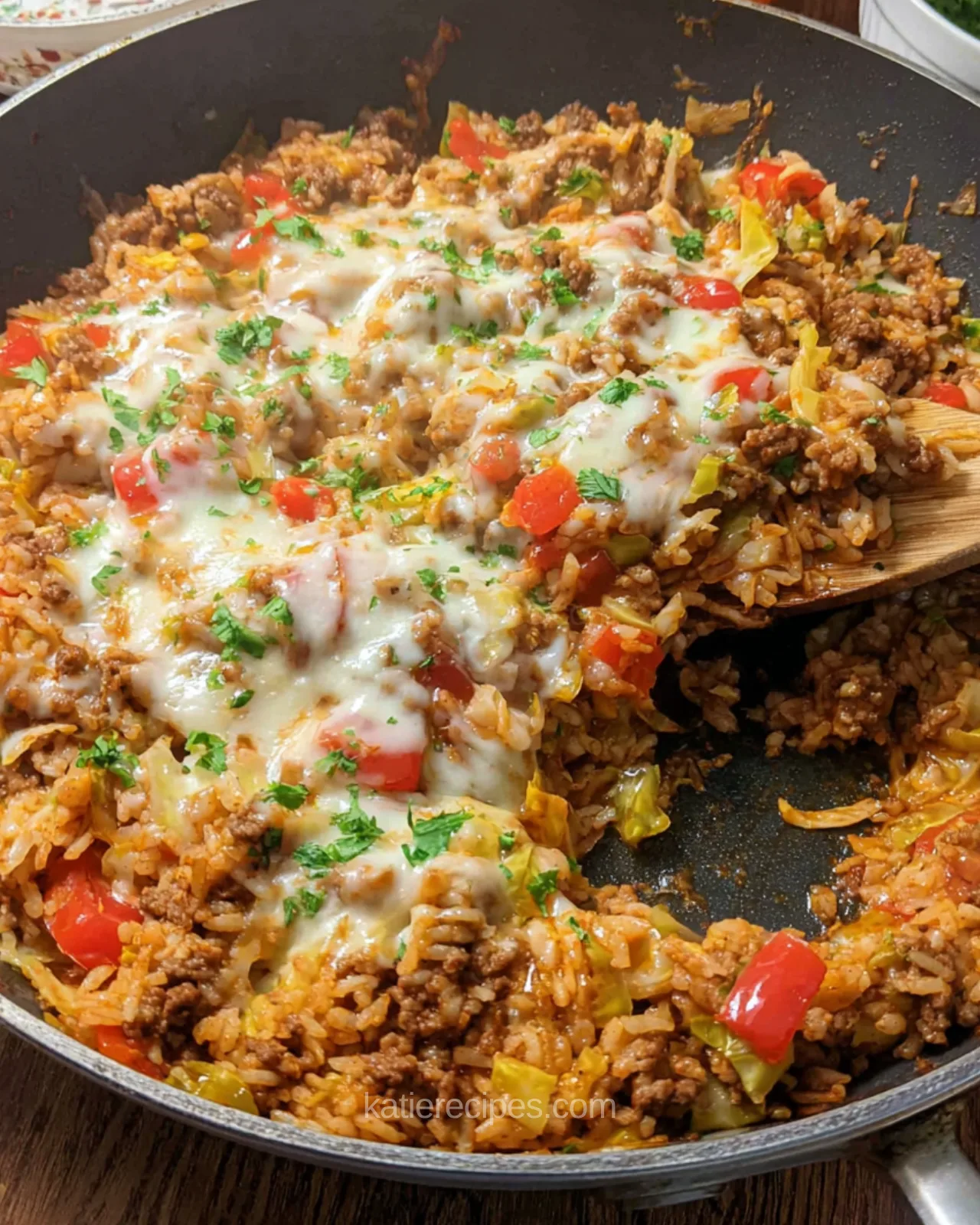 Unstuffed cabbage roll skillet with ground beef, rice, cabbage, red pepper, and melted mozzarella