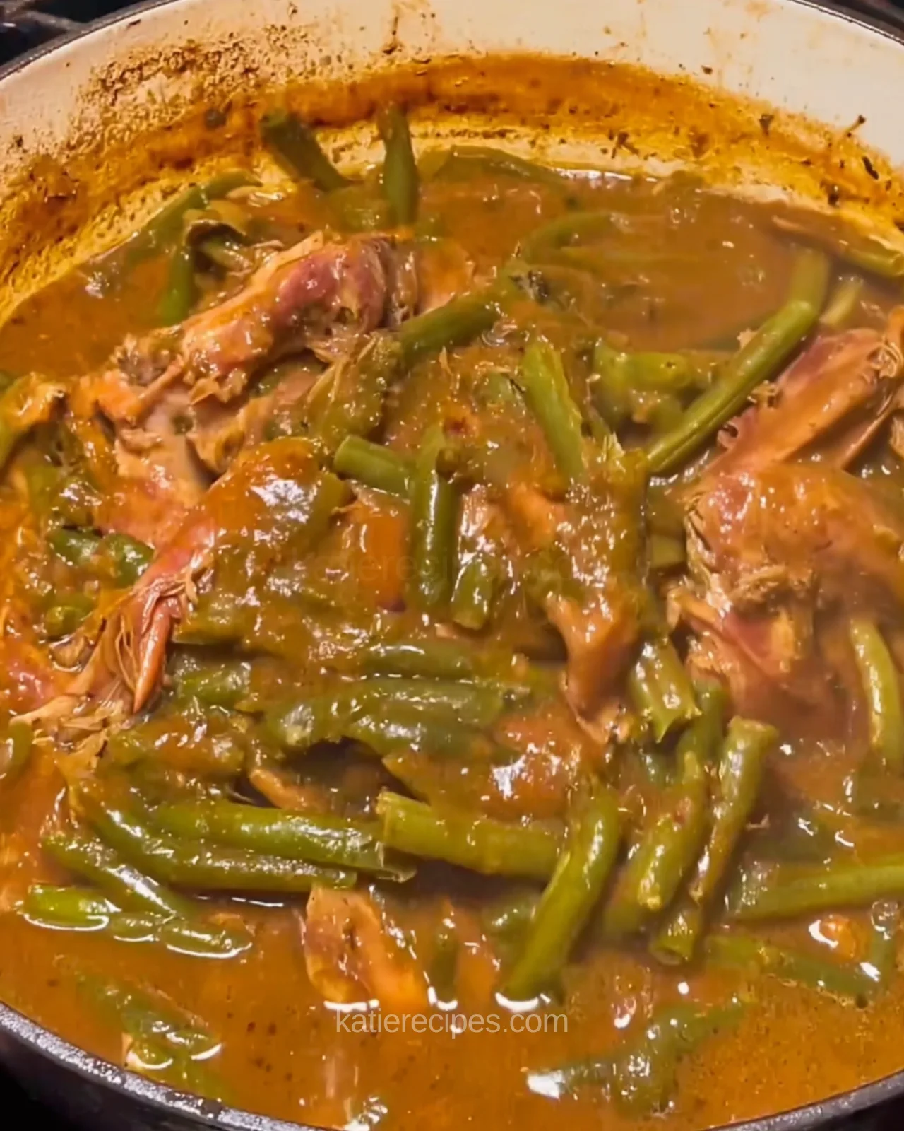Dutch oven of smothered green beans with smoked turkey legs in gravy