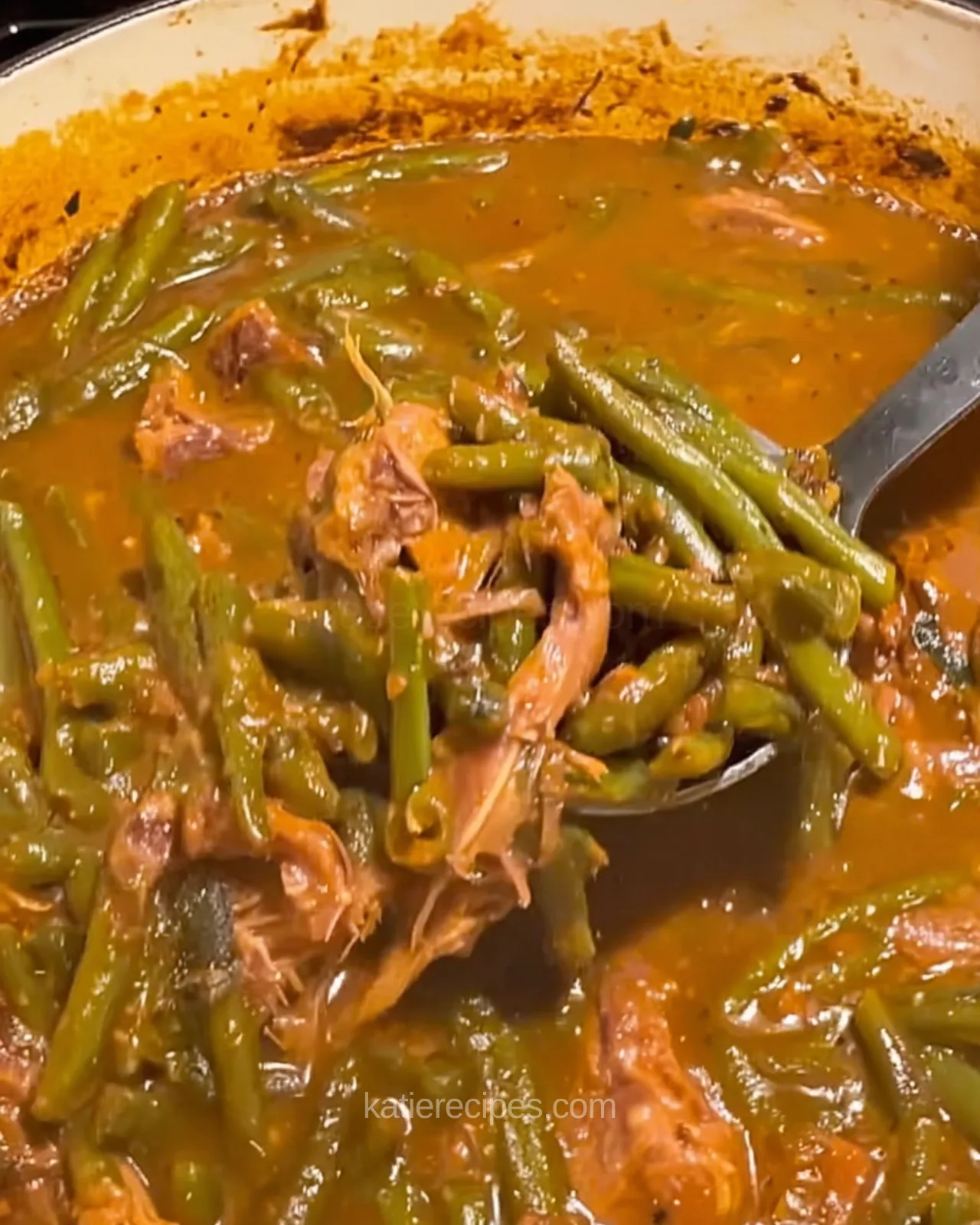 Southern smothered green beans and pulled smoked turkey lifted from a Dutch oven