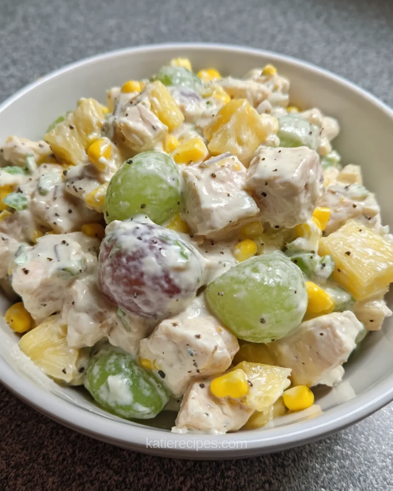 Close-up of royal delight salad with whole and halved grapes, chicken, pineapple and corn in a creamy dressing